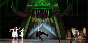 dancers on stage performing dracula ballet with ominous set in the background